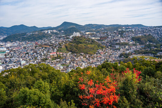 Views of Nagasaki with autumn leaves and terraced hills over city slopes by the bay