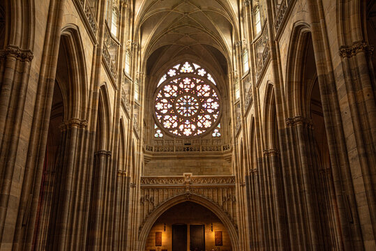 View of Gothic vaults and rose window in St. Vitus Cathedral in Prague during daylight