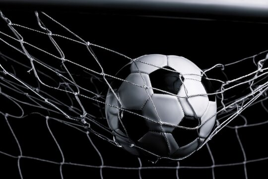 Soccer ball goal success on black background