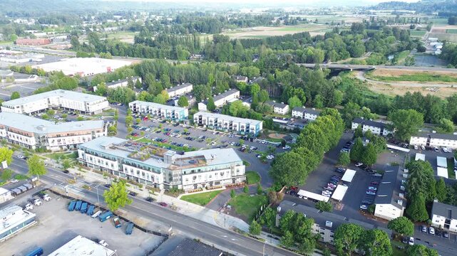 Baseball diamonds occupy central park zone near dense tree lined boundaries in Kent, WA. Infrastructure supports community engagement framing active recreational space in greater Seattle landscape