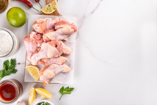 Fresh raw organic chicken wings, with spices and condiments
