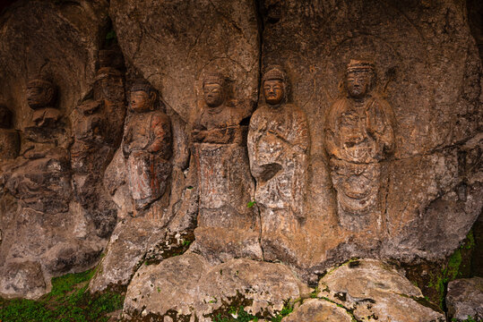 Stone-carved Buddhist figures from late Heian to Kamakura period in Usuki, Japan showcase ancient artistry in volcanic rock cliffs