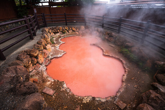 Red geothermal pool in Beppu from iron oxide deposits formed by volcanic activity beneath the city