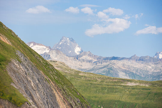 View of rugged peaks and glacial cirques in the Bernese Alps from the Nufenen region in Switzerland on a clear day