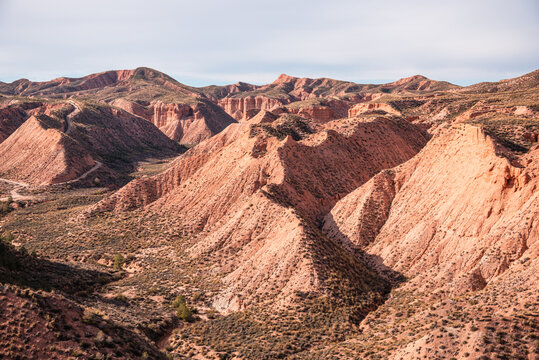 Exploration of badlands formations showcasing erosion patterns and geological history in Spain's geopark area near Gorafe village