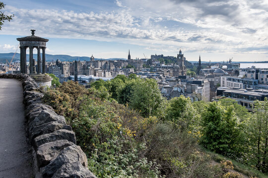 View of Edinburgh's Old Town from Calton Hill shows Dugald Stewart Monument and historic skyline with castle and spires