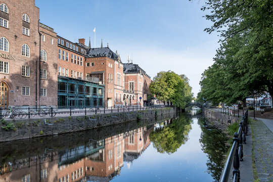 Urban landscape near Norrlands Nation along the Fyris River in Uppsala with riverside buildings and reflections