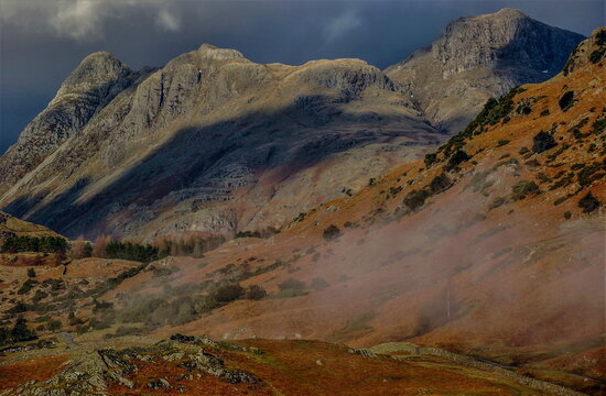 View from Little Langdale Valley towards Langdale Pikes in English Lake District during overcast weather
