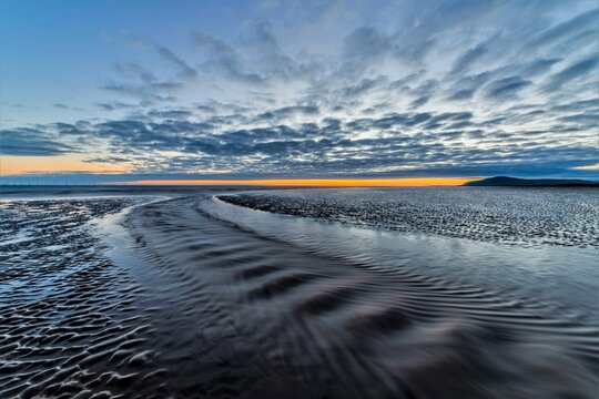 Summer solstice sunset at Sandy Gap with view towards Black Combe on Walney Island in June 2022