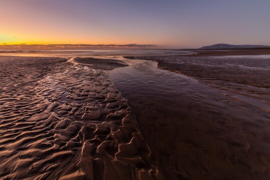 Sunset view at Sandy Gap on Walney Island with water and sand patterns along the beach