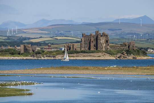 View from South Walney Nature Reserve showing Piel Castle, surrounding landscape, and distant mountains in the Lake District