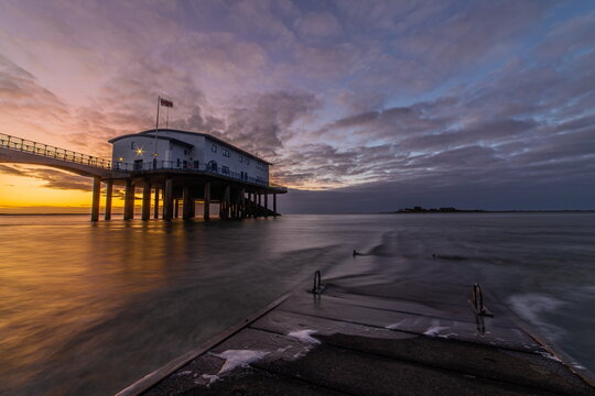 Sunrise view from Roa Island Lifeboat Station towards distant Piel Island on the Cumbrian Coast in the UK