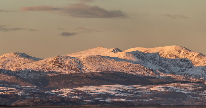 Winter conditions on the mountains of the English Lake District with a view toward distant peaks and snow-covered areas