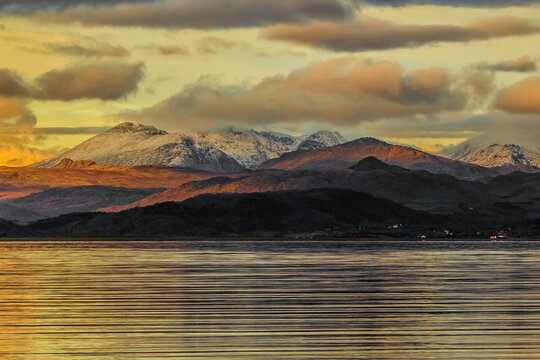 View of Scafell mountain range from Roanhead across Duddon Estuary in Cumbria during sunset