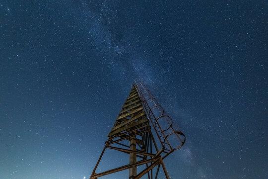 Starry skies shine above Decca Tower on the Cumbrian Coast in the UK during clear night
