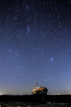 Stars shine brightly over the derelict trawler Vita Nova in Cumbria during a clear night