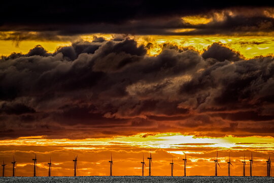 Sunset view with clouds gathering over Irish Sea and windfarm in Walney Island, UK on November 8, 2023