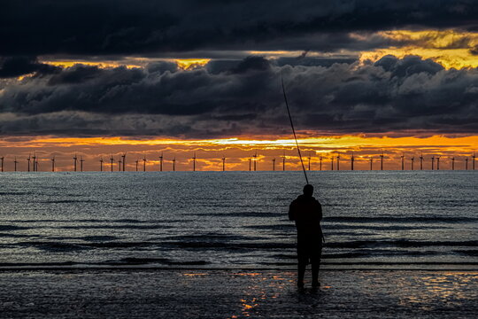 Sunset fishing at Walney Island with wind farm in the background on November 8 2022