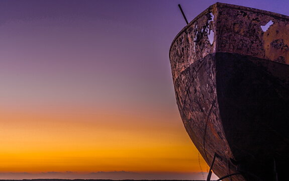 Sunrise over the derelict trawler Vita Nova on the Cumbrian Coast