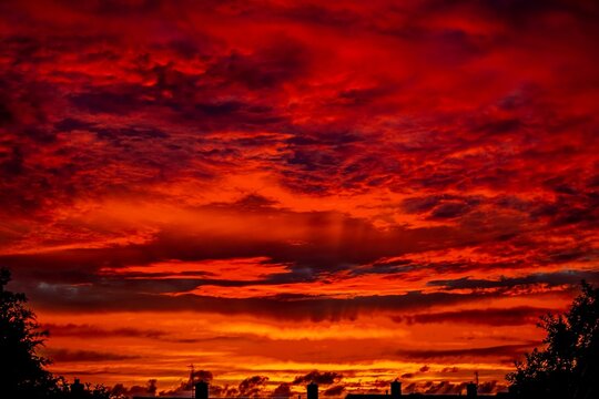 Sunset view over Barrow In Furness with bright red and orange sky and silhouettes of buildings