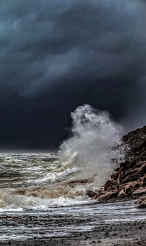 Breezy weather at Walney Island with waves crashing on rocky shore towards Black Combe in the UK