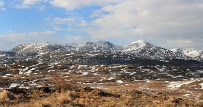 Snowfall covers Coniston mountain range from viewpoint in English Lake District during winter season