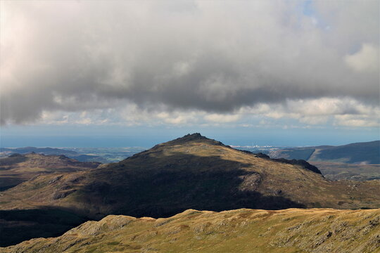 View from Coniston Old Man towards Harter Fell and Sellafield on a cloudy day in the UK