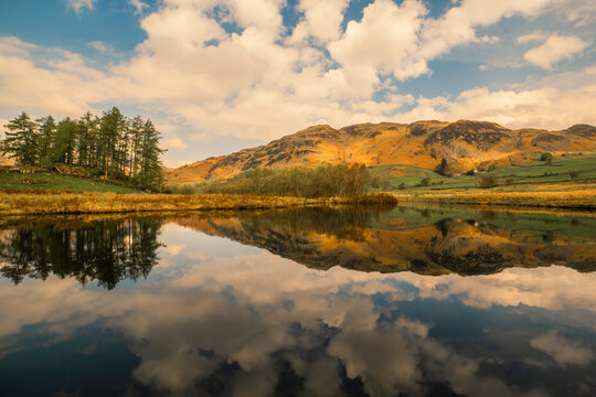 Reflections on the river brathay with lingmoor fell in the background in little langdale valley, english lake district, cumbria