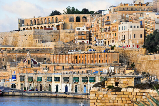 Scenic view of Quarry Wharf and buildings in Valletta harbor showing the city's rich architecture and waterfront activity