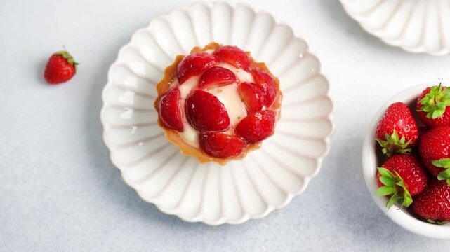 Strawberry tart on a white plate with strawberries