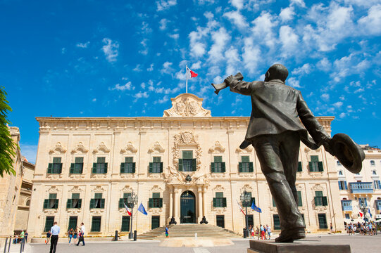 Manwel Dimech statue stands at Castille Square with auberge de Castille in background in Valletta, Malta