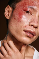 Naklejka premium A stylish young Asian man with striking features poses confidently, highlighting his fashion sense.