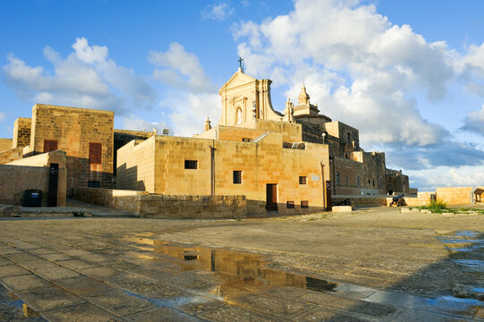 Explore the Cathedral of the Assumption in Cittadella, Gozo Island with vibrant skies and historic architecture