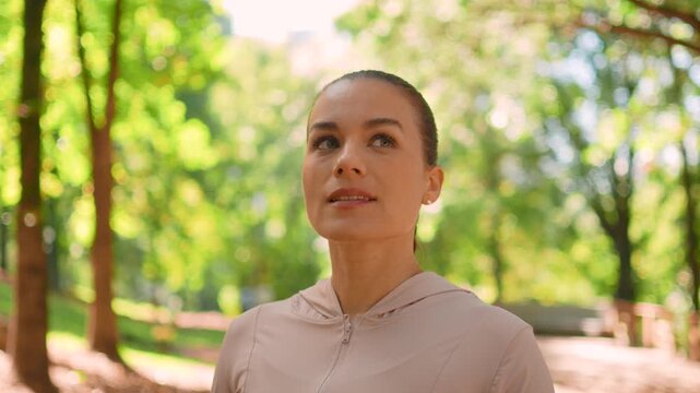 Peaceful, woman and mindfulness in nature with calm, satisfaction or wellness outdoor. Close up, athlete or person admiring surroundings, reflection and inner peace in forest.