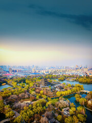 Fototapeta premium Aerial View of Urban Park with Lakes and Bridges at Sunrise