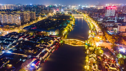 Fototapeta premium Night View of Urban River with Traditional and Modern Buildings