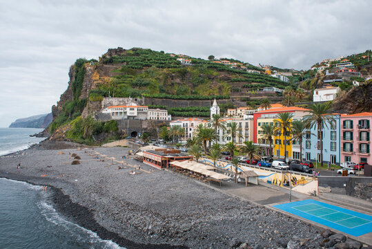 Visit to the seafront area of Ponta do Sol showing buildings, beach, and rocky coastline on Madeira Island in Portugal