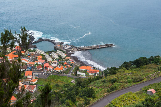 Harbour and beach scene at Seixal with public swimming pool and coastal views in Madeira