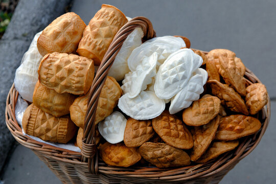 Enjoying Oscypek cheese displayed in a basket in Krakow, Poland, Central Europe with traditional shapes and textures