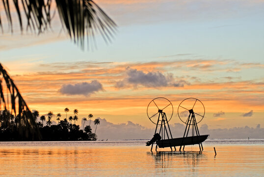 Pulley system raises boats in dry location during sunset on Raiatea island in French Polynesia
