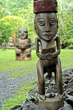 Sculptures stand at Marae Arahurahu in Paea, Tahiti, showcasing Polynesian culture and history in French Polynesia