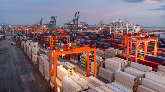 Smart RTG crane loading cargo container to container truck in the international terminal logistic depot sea port  concept freight shipping transportation and service concept
