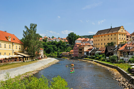 Canoes navigate the Vltava river near Cesky Krumlov Castle in South Bohemia, Czech Republic and showcase local outdoor activities