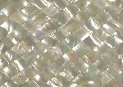 Antique mother of pearl inlay background, diamond pattern mosaic texture with iridescent surface. Vintage decorative material.