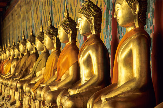 Gallery of Buddhas displayed in the cloister at Wat Arun in Bangkok showcasing vibrant history and culture