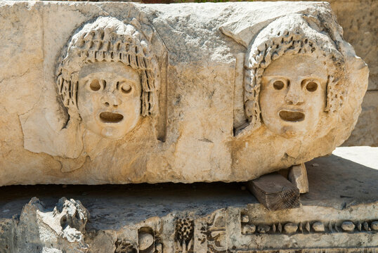 Stone faces sculpture detail from theater at archaeological site of Myra in Demre showcases ancient artistry and craftsmanship in Turkey