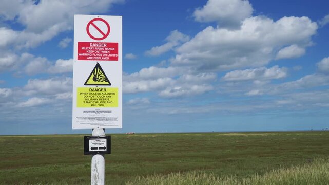 British army base warning signs. Danger of unexploded weapons on a Lincolnshire beach danger of explosions and death. Keep our. Environmental issues and destruction of nature