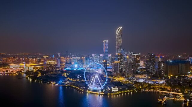 Aerial night view of the city skyline of Jinji Lake and Ferris wheel in Suzhou, Jiangsu Province, China