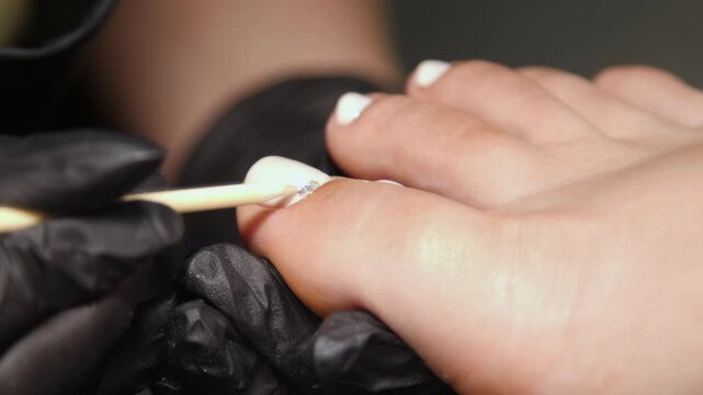 A woman's feet during a pedicure. Woman getting pedicure in beauty salon, closeup. A pedicurist working at a beauty salon. Beauty salon concept: pedicures.