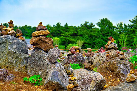Stone stacks at Daepo Jusangjeolli Cliff in Jeju Island display human creativity and nature's beauty under the open sky